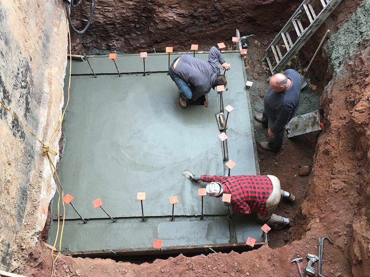 Masons pour concrete slab for elevator shaft